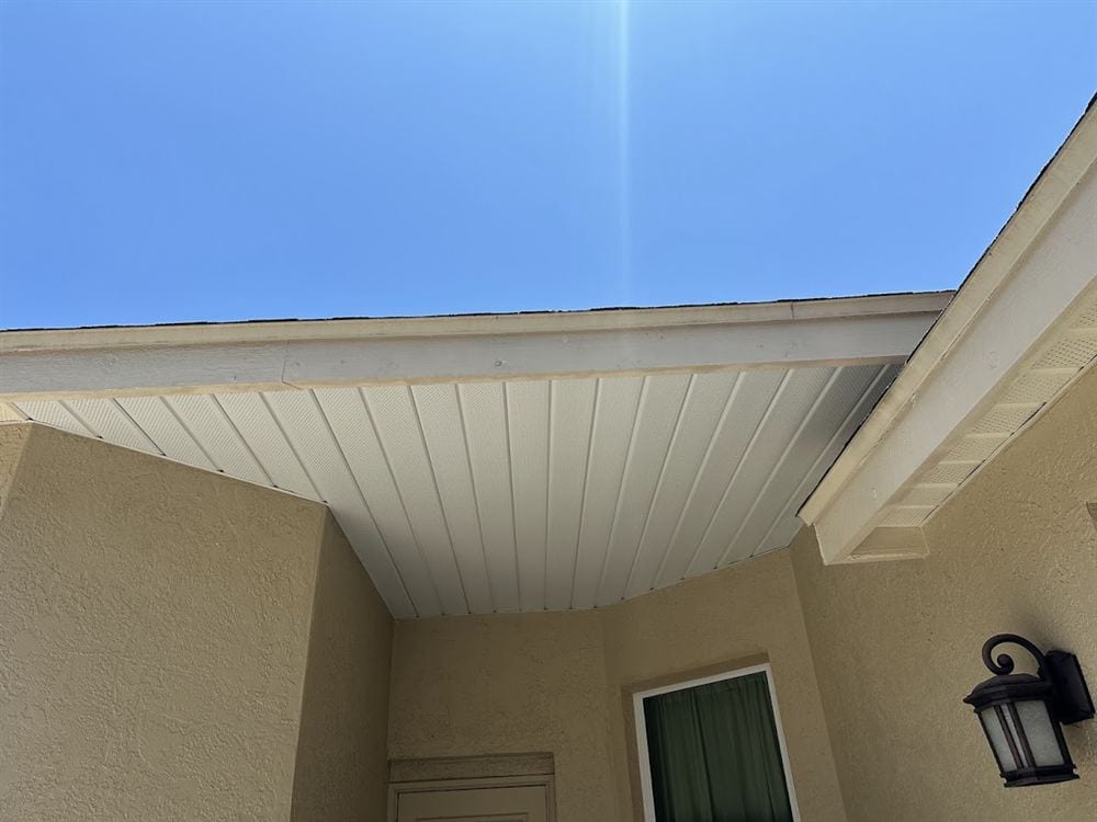 White vented soffit above a stucco entry.